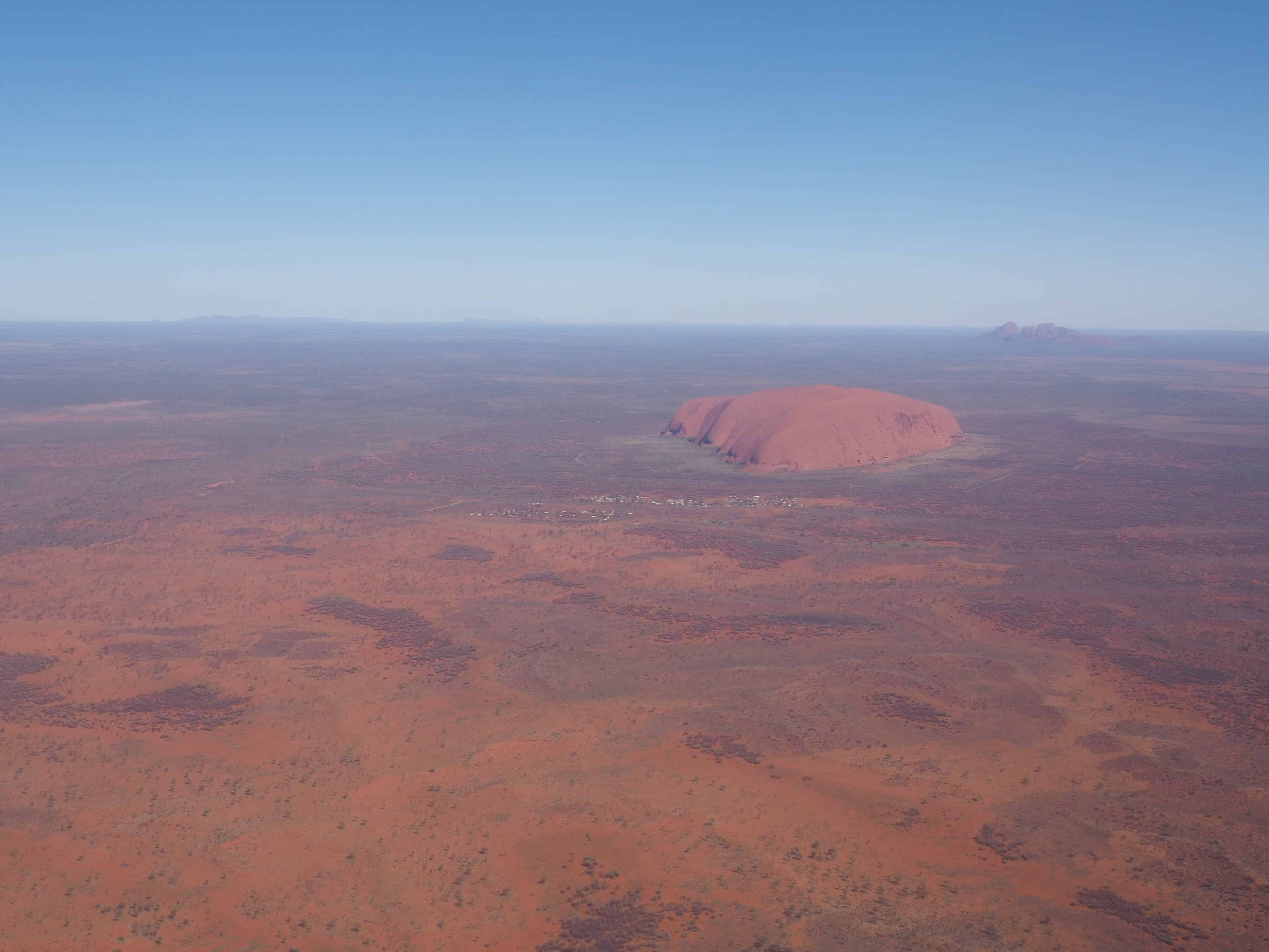 A rippled red sand dune against a clear blue sky, taken near Uluru in  central Australia Stock Photo